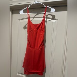 Red spaghetti strap v-neck dress with cinched sides and ruffle bottom